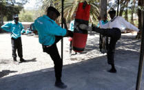 Kenyan security guards participate in physical exercise during martial arts combat training at the Chinese-run Deway Security Group compound in Kenya's capital Nairobi, March 13, 2017. REUTERS/Thomas Mukoya