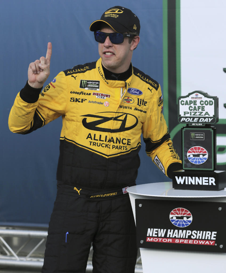 Brad Keselowski poses after winning the pole during qualifying for Sunday's NASCAR Cup Series auto race at New Hampshire Motor Speedway in Loudon, N.H., Friday, July 19, 2019. (AP Photo/Charles Krupa)