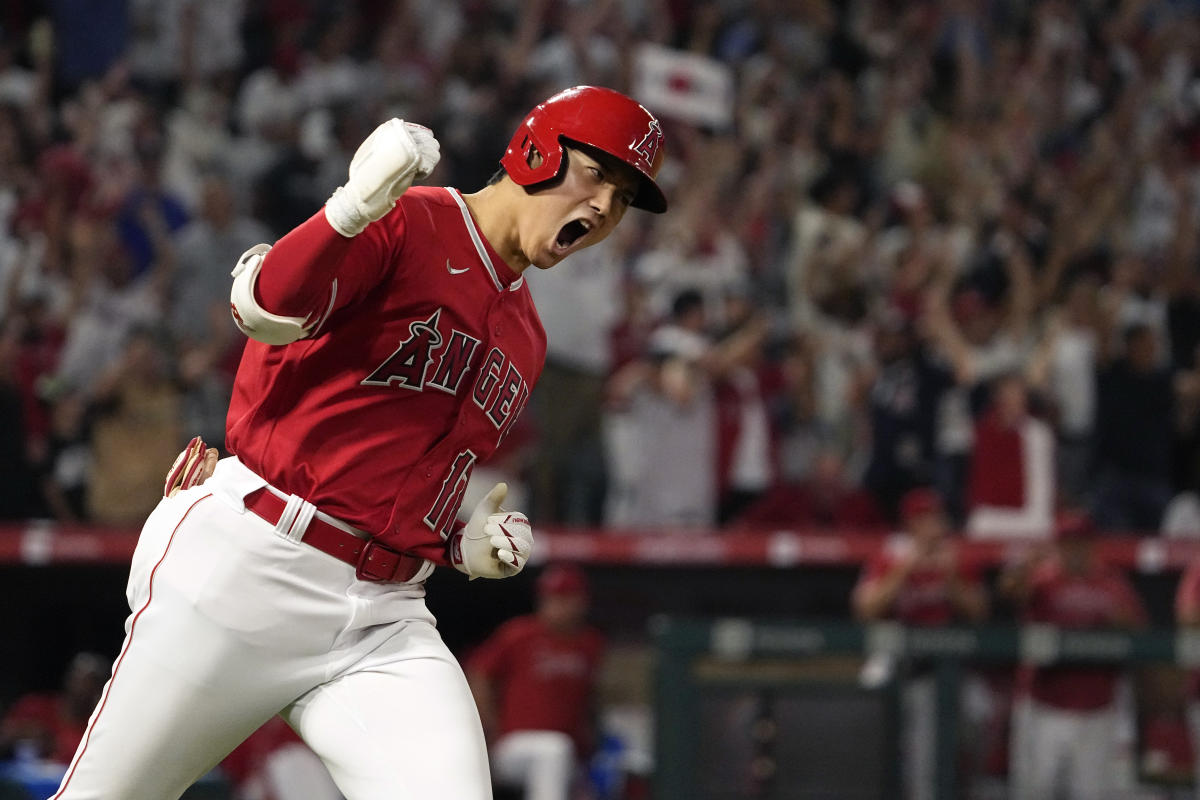 Shohei Ohtani of the Los Angeles Angels reacts after drawing a walk in the  fifth inning of a spring training baseball game against the Chicago Cubs on  March 24, 2022, in Tempe