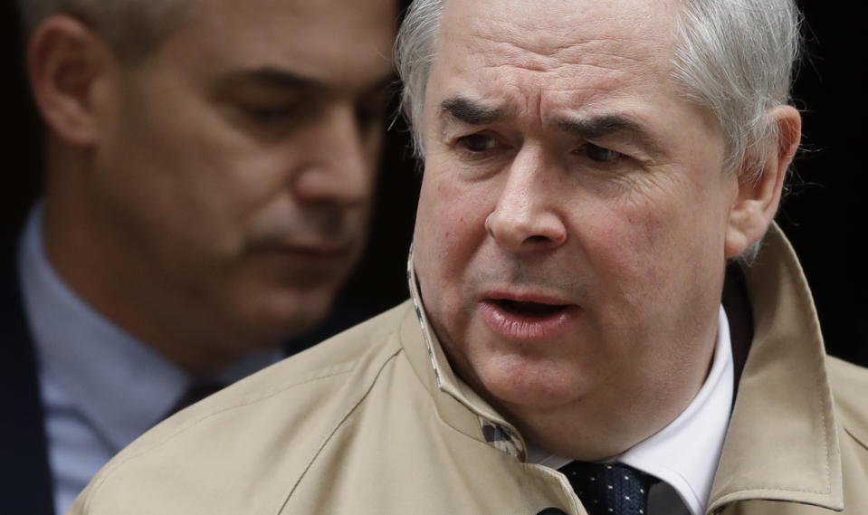 Geoffrey Cox, Britain's Attorney General looks down as he leaves 10 Downing Street following a cabinet meeting in London, Wednesday, March 13, 2019. In the background is Stephen Barclay, Secretary of State for Exiting the European Union. (AP Photo/Matt Dunham)