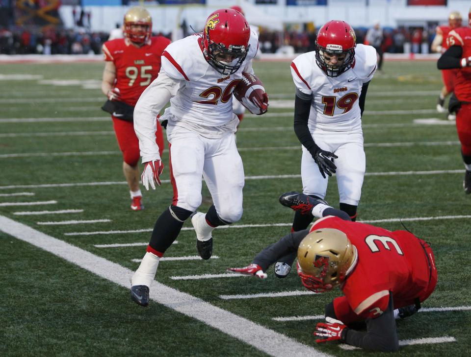 Calgary Dinos Mercer Timmis (20) knocks down Laval Rouge et Or Alexander Hovington as he goes out of bounds on a long run during the second half of the Vanier Cup University Championship football game in Quebec City, Quebec, November 23, 2013. REUTERS/Mathieu Belanger (CANADA - Tags: SPORT FOOTBALL)