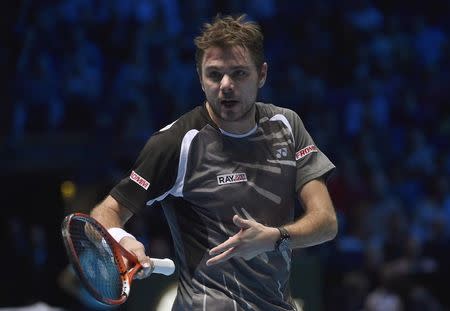 Stan Wawrinka of Switzerland gestures towards the coaches and family box of Roger Federer of Switzerland, during their semi-final tennis match at the ATP World Tour Finals at the O2 Arena in London November 15, 2014. REUTERS/Toby Melville