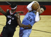 Memphis Grizzlies guard Dillon Brooks (24) attempts to keep control of the ball as Houston Rockets forward Danuel House Jr. (4) defends during the third quarter of an NBA basketball game Sunday, Feb. 28, 2021, in Houston. (Troy Taormina/Pool Photo via AP)