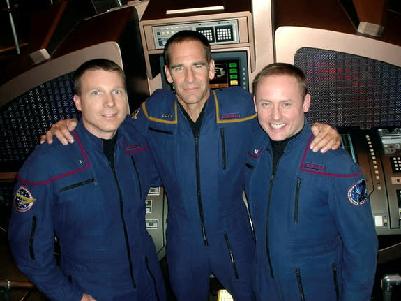 Scott Bakula, who played Captain Jonathan Archer on Star Trek: Enterprise, stands with astronauts Terry Virts and Mike Fincke on set. The two astronauts made guest appearances on the series finale episode “The