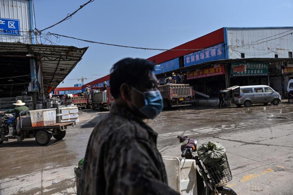 A man wearing a face mask walks at the Wuhan Baishazhou Market in Wuhan (AFP via Getty Images)