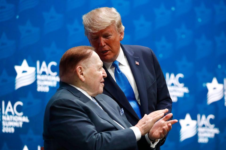 President Donald Trump speaks with Las Vegas Sands Corporation Chief Executive and Republican mega donor Sheldon Adelson before speaking at the Israeli American Council National Summit in Hollywood, Fla., Saturday, Dec. 7, 2019. (AP Photo/Patrick Semansky)