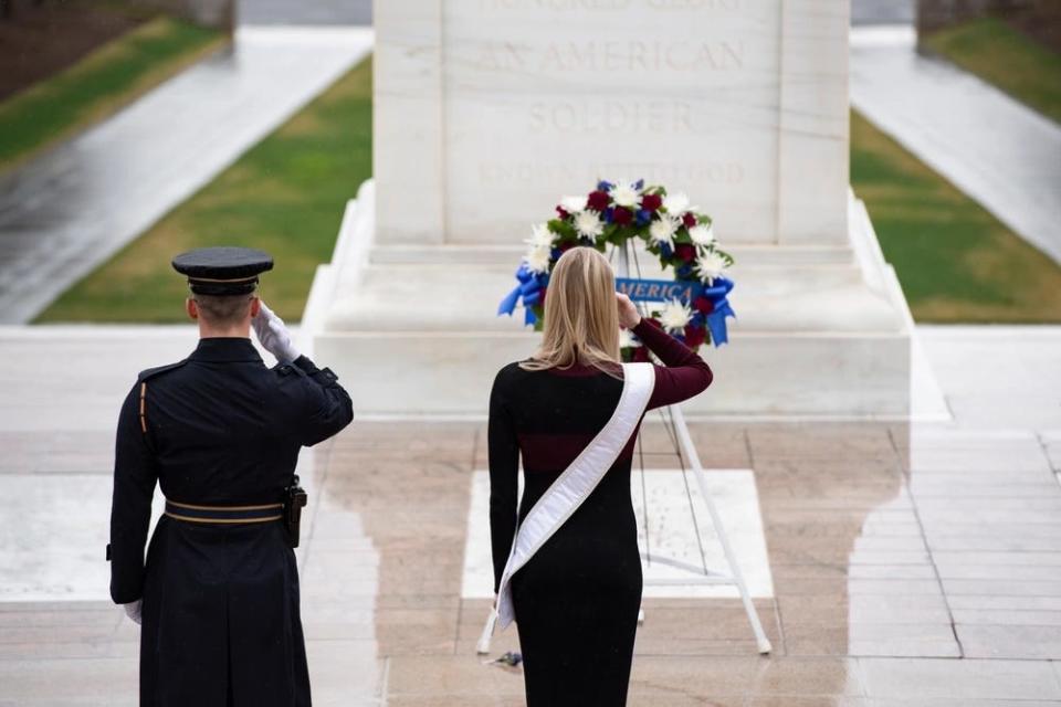 Second Lt. Madison Marsh salutes in front of a wreath at the Tomb of the Unknown Soldier
