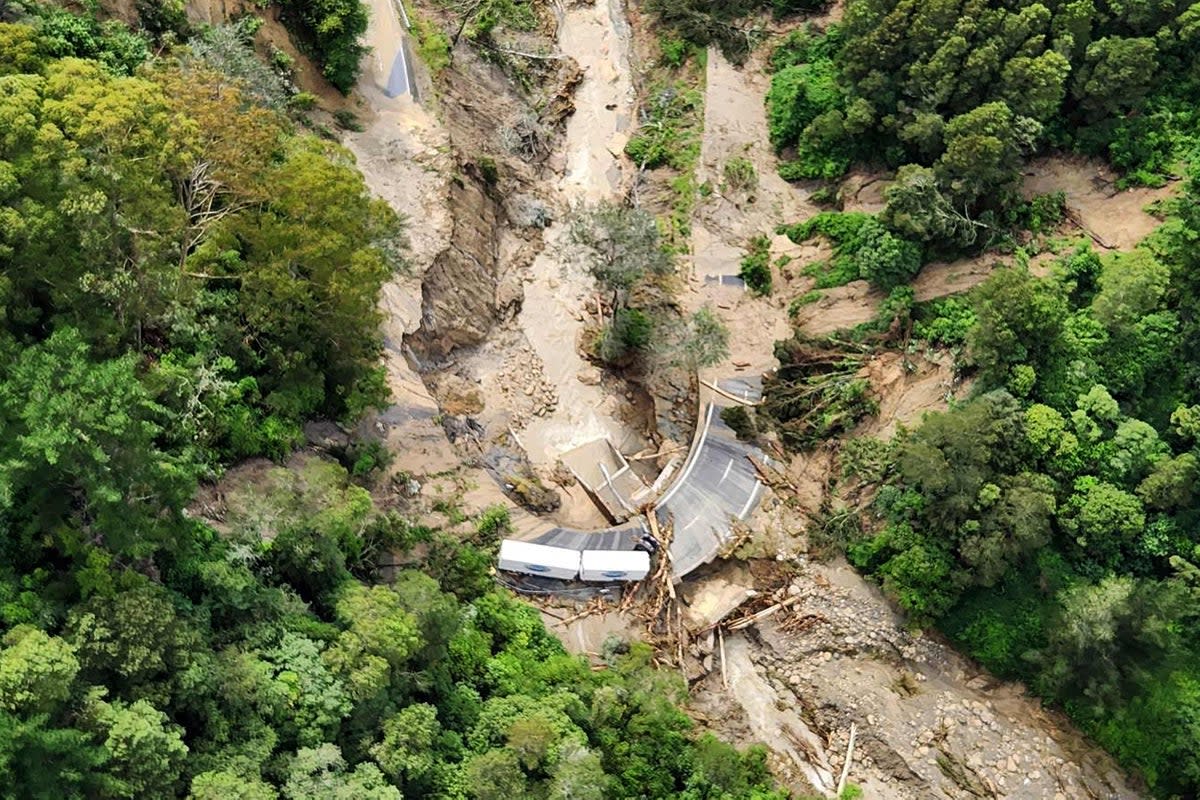 A lorry stranded on a road covered with debris near Wairoa (New Zealand Defence Force/AFP vi)