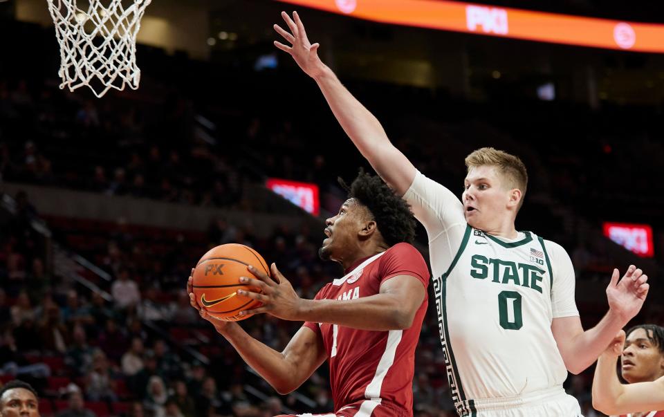 Alabama guard Mark Sears, front left, shoots in front of Michigan State forward Jaxon Kohler (0) during the first half of an NCAA college basketball game in the Phil Knight Invitational tournament in Portland, Ore., Thursday, Nov. 24, 2022. (AP Photo/Craig Mitchelldyer)