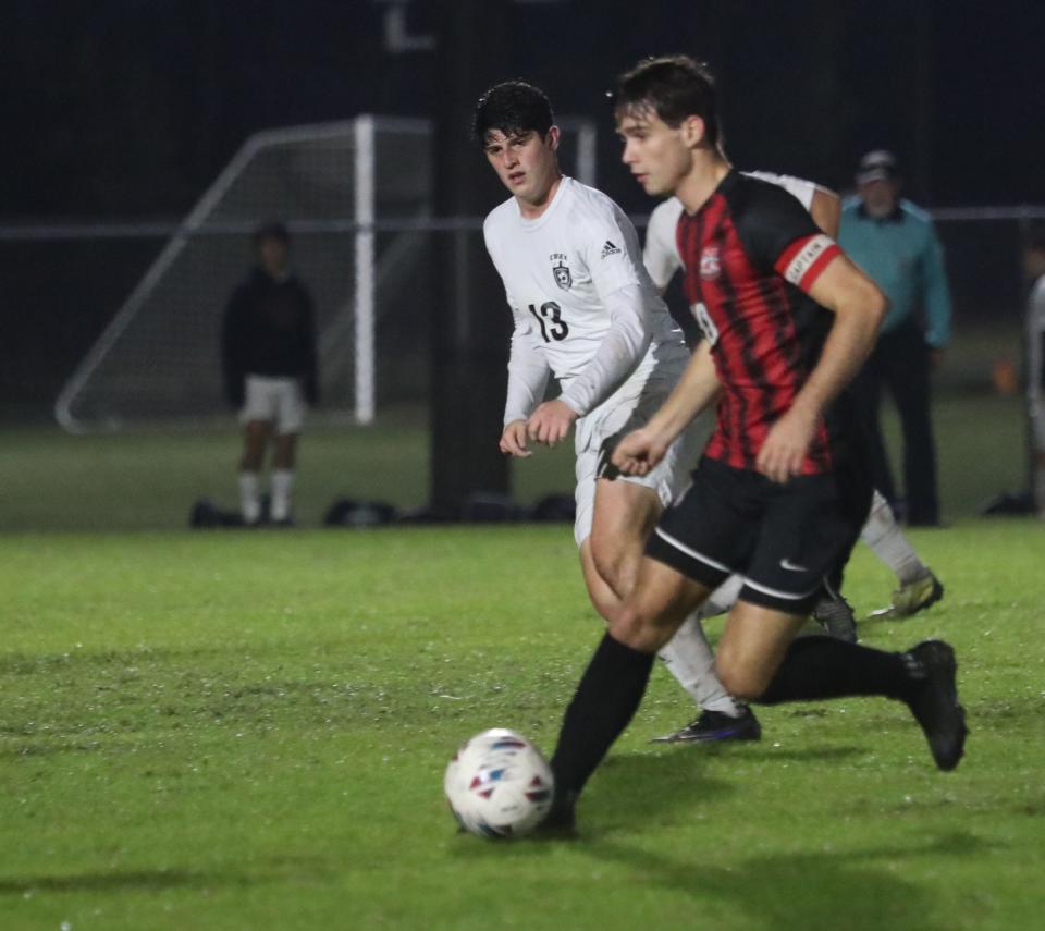 New Smyrna Beach High's Brooks Beeman (10) charges toward the goal as Spruce Creek High's Bennett Morse (13) gives chase, Thursday, January 18, 2024 during the Five Star Conference boys soccer final.