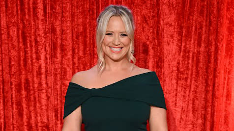  Emmerdale star Amy Walsh in a black dress against a red background.  