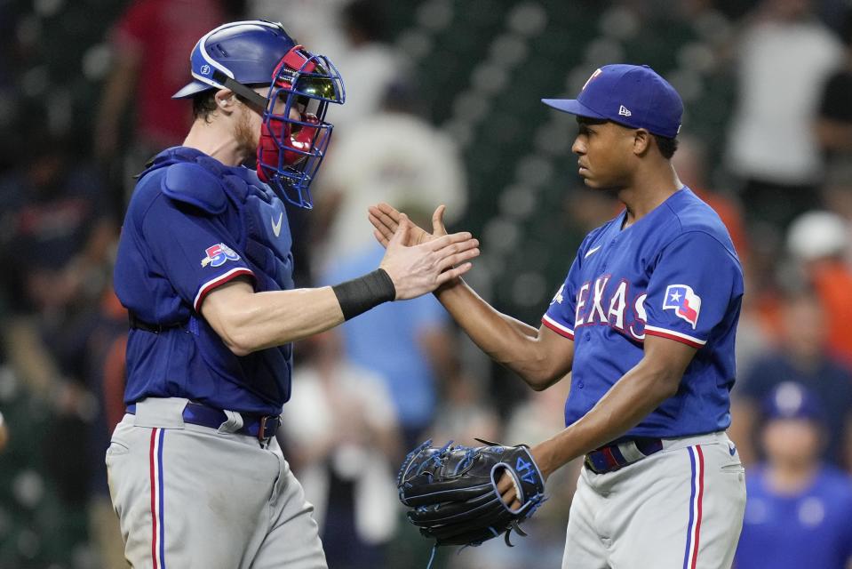 Texas Rangers relief pitcher Jose Leclerc, right, and catcher Sam Huff clasp hands after the team's victory over the Houston Astros in a baseball game, Tuesday, Sept. 6, 2022, in Houston. (AP Photo/Eric Christian Smith)