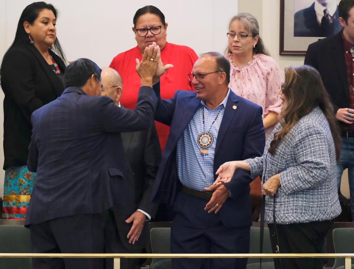 Muscogee Nation Principal Chief David Hill, left, high fives Choctaw Nation Chief Gary Batton on Monday after the Oklahoma House voted to extend cigarette tax compacts with tribal nations.