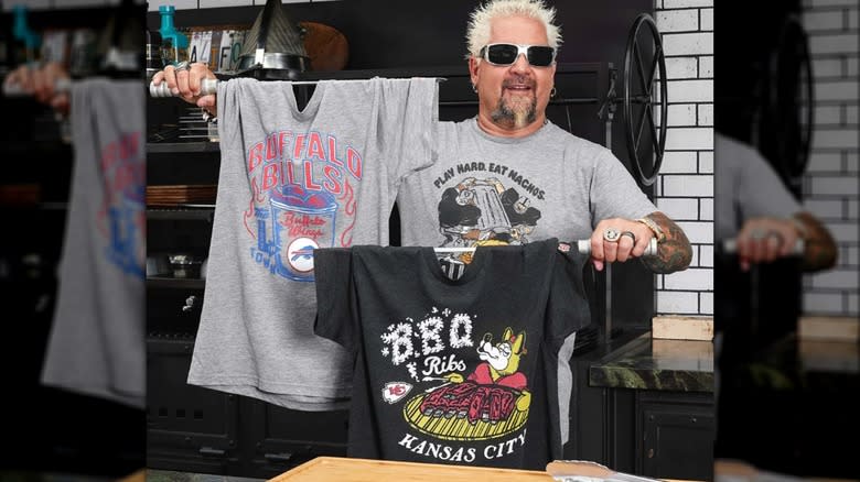 Guy Fieri holding up t-shirts