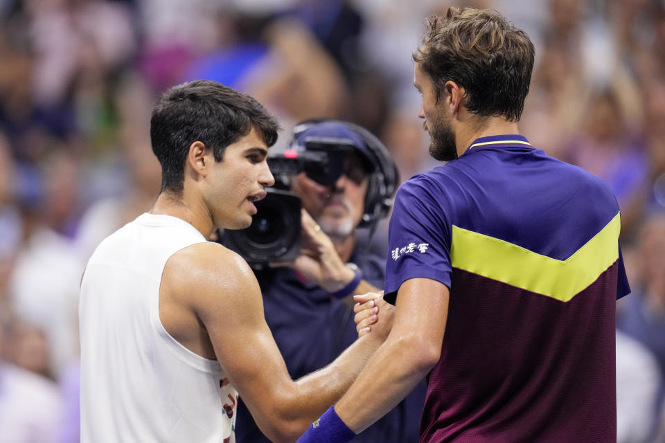 Carlos Alcaraz, of Spain, left, shakes hands with Daniil Medvedev, of Russia, after Medvedev won their singles semifinal of the U.S. Open tennis championships, Friday, Sept. 8, 2023, in New York. (AP Photo/Manu Fernandez)