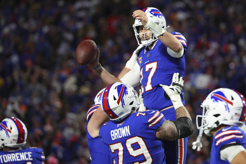 Buffalo Bills quarterback Josh Allen, top, celebrates after scoring a touchdown during the second half of an NFL football game against the Denver Broncos, Monday, Nov. 13, 2023, in Orchard Park, N.Y. (AP Photo/Jeffrey T. Barnes)