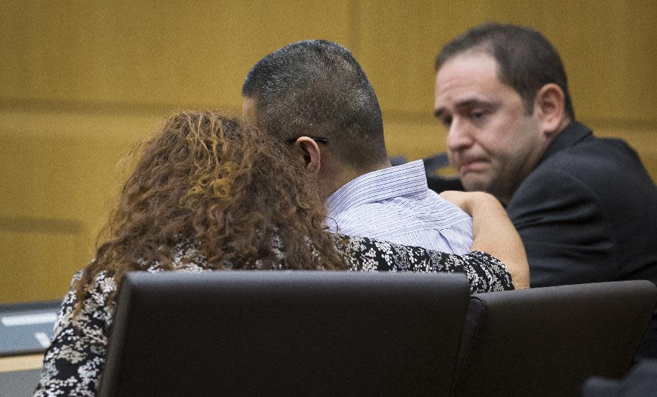 Johnathan Doody, center, is consoled by attorney Maria Schaffer as his other attorney, David Rothschild looks on, as the court clerk reads guilty verdicts on all counts, Thursday, Jan. 23, 2014, in Maricopa County Superior Court. Doody was on trial for the 1991 killings of nine people, including six monks, at a suburban Phoenix Buddhist temple. (AP Photo/The Arizona Republic, ) MARICOPA COUNTY OUT; MAGS OUT; NO SALES MBO (Charlie Leight/The Arizona Republic)
