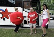 Iowa Lottery spokeswoman Mary Neubauer, right, greets workers from the Quaker Oats plant in Cedar Rapids, Iowa, as they arrive to cash in their winning $241 million Powerball ticket at the Iowa Lottery headquarters, Wednesday, June 20, 2012, in Des Moines, Iowa. Neubauer says one of the workers bought the winning ticket for the group for the June 13 drawing and the winnings will be split 20 ways.(AP Photo/Charlie Neibergall)