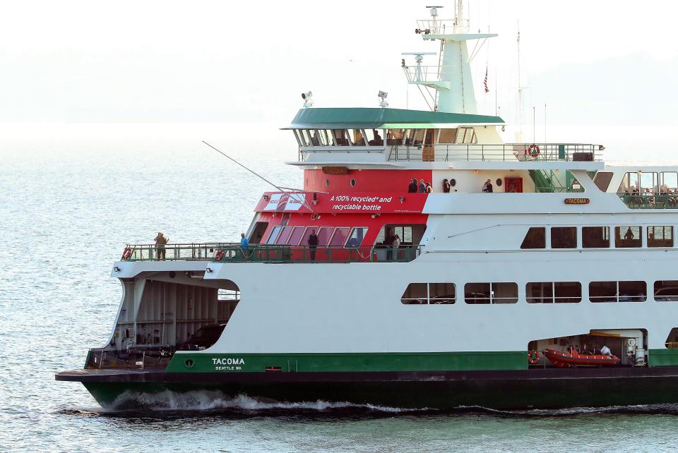 The Washington State Ferries vessel Tacoma, wrapped in red Coca-Cola advertising, enters Bainbridge Island’s Eagle Harbor on Oct. 5.