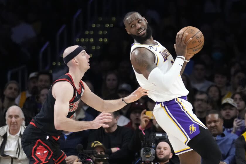 Los Angeles Lakers forward LeBron James, right, is defended by Chicago Bulls guard Alex Caruso.