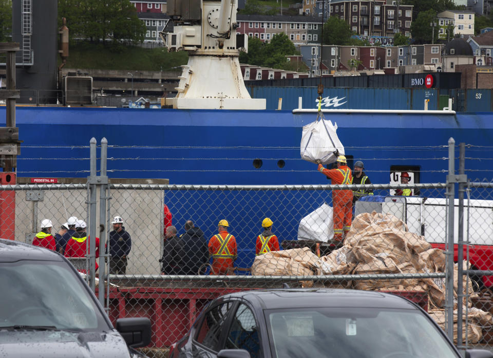 Debris from the Titan submersible, recovered from the ocean floor near the wreck of the Titanic, is unloaded from the ship Horizon Arctic at the Canadian Coast Guard pier in St. John's, Newfoundland on Wednesday, June 28, 2023. (Paul Daly/The Canadian Press via AP)