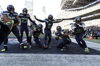 Seattle Seahawks safety Quandre Diggs (6) celebrates with teammates after intercepting a pass during the first half of an NFL football game against the Las Vegas Raiders Sunday, Nov. 27, 2022, in Seattle. (AP Photo/Caean Couto)