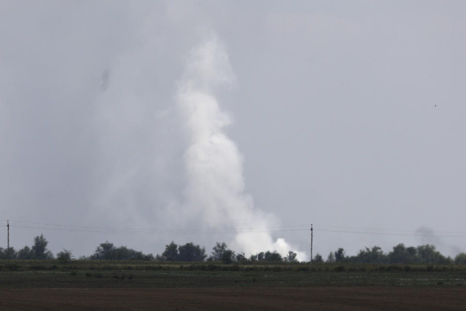 Smoke rises over the site of explosion at an ammunition storage of Russian army near the village of Mayskoye, Crimea, Tuesday, Aug. 16, 2022. Explosions and fires ripped through an ammunition depot in Russian-occupied Crimea on Tuesday in the second suspected Ukrainian attack on the peninsula in just over a week, forcing the evacuation of more than 3,000 people. (AP Photo)