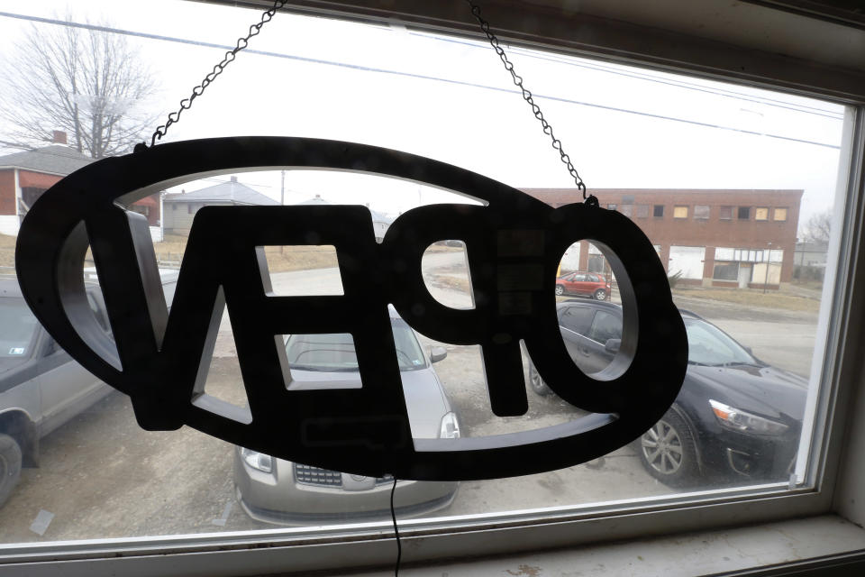 In this photo made on Saturday, March 1, 2014, the back of the "open" sign hangs in the window at Bobtown Pizza in Bobtown, Pa. The little pizza shop in the southwestern corner of Pennsylvania was placed in the spotlight when energy giant Chevron offered coupons for free pizza from their shop to people who live near the area where a natural gas well that exploded, killing one worker on Feb 11, 2014. Some news stories and internet opinion posts have been critical about the offer by Chevron Corp., but many residents of the town said they didn’t mind the pizza offer. (AP Photo/Keith Srakocic)