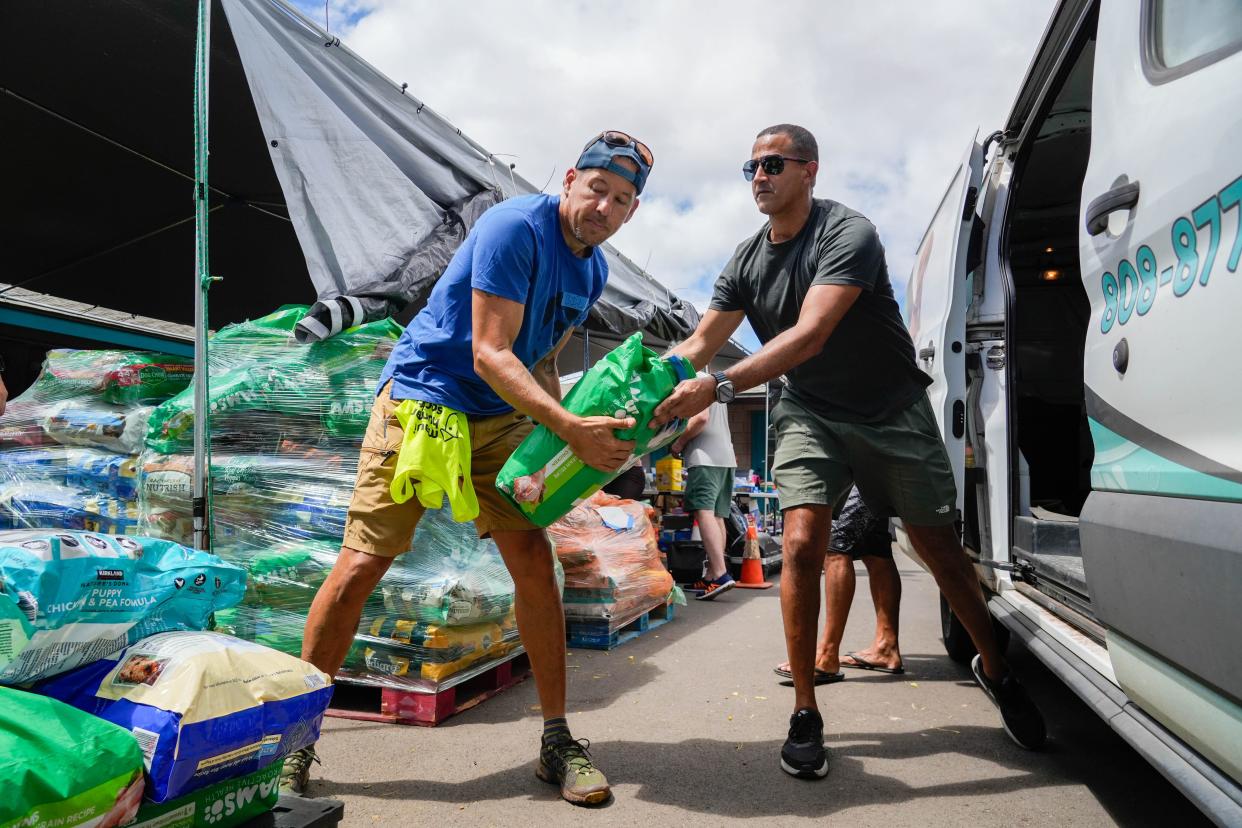 Volunteers unload pet food donations at Maui Humane Society in Puunene on Aug. 15, 2023. The organization estimates that over 3,000 animals are lost or missing from the fire and are treating found animals for severe burns and smoke inhalation.