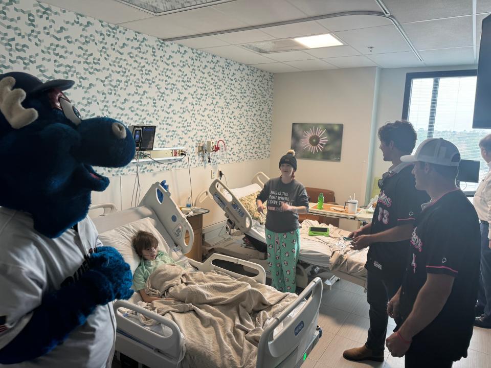 Pensacola Blue Wahoos players Jacob Berry and Ike Buxton, along with team mascot Kazoo, take a picture with Milton's Jackson Jordan at the HCA Florida West Hospital on Thursday, Jan. 18, 2024.