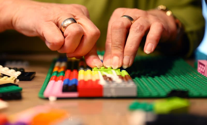 Rita Ebel, nicknamed "Lego grandma", builds a wheelchair ramp from donated Lego bricks in the living room of her flat in Hanau