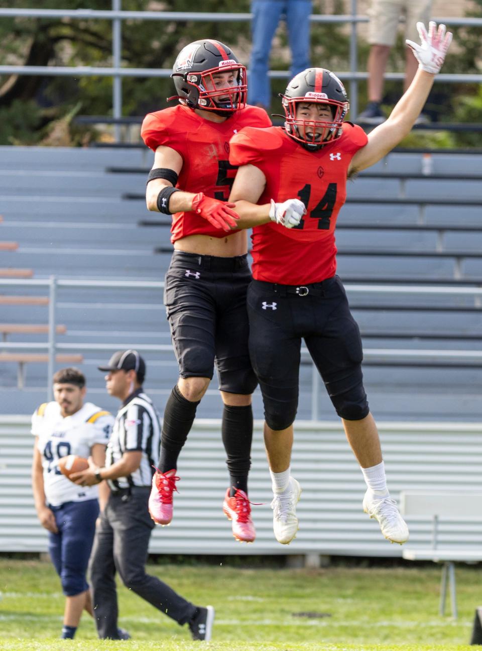 Grinnell College’s Davis Cooper and Jio Hong celebrate after a defensive stop in the fourth quarter against Beloit on Oct. 1 in Grinnell.