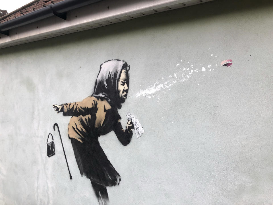 Banksy's latest mural titled “Aachoo!!” that has appeared on a wall in Bristol, England, Thursday Dec. 10, 2020. Banksy's latest mural has delayed - but not thwarted - a homeowner's plans to sell in Bristol after it recently appeared on the house's exterior wall. (Claire Hayhurst/PA via AP)