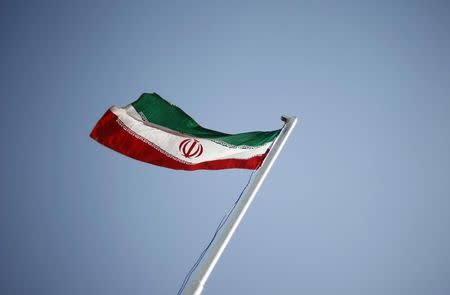 An Iranian national flag flutters during the opening ceremony of the 16th International Oil, Gas & Petrochemical Exhibition (IOGPE) in Tehran April 15, 2011. REUTERS/Morteza Nikoubazl