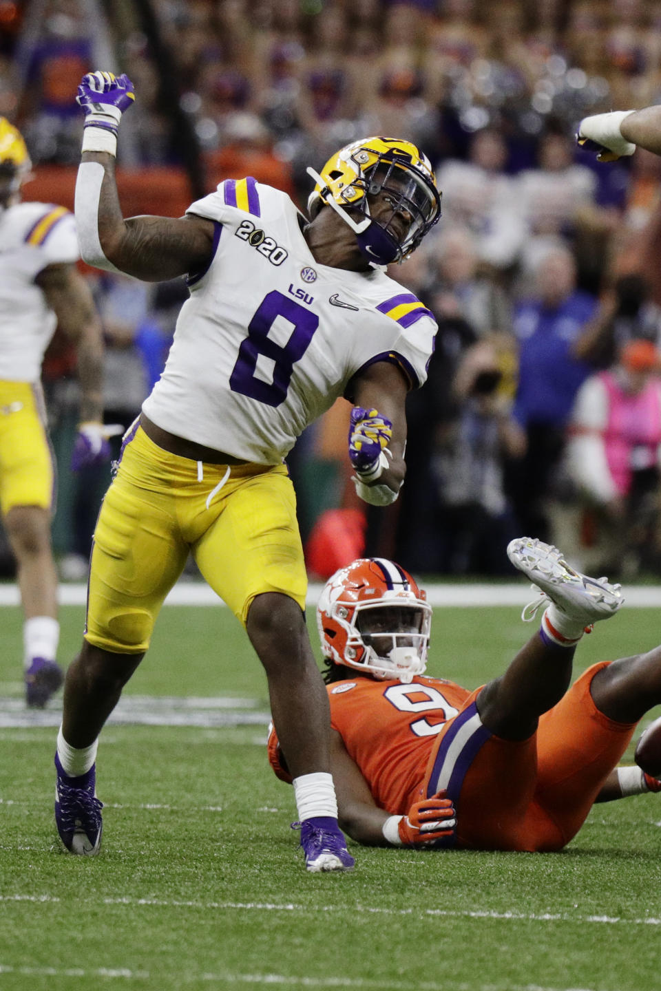 LSU linebacker Patrick Queen celebrates after tackling Clemson running back Travis Etienne during the second half of a NCAA College Football Playoff national championship game Monday, Jan. 13, 2020, in New Orleans. (AP Photo/Sue Ogrocki)