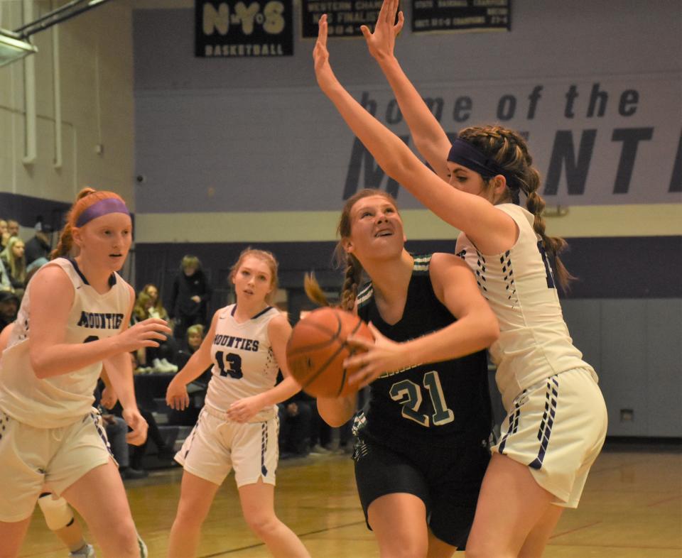 Herkimer Magician Arrissa Bunker (21) looks for room to shoot with Olivia Brand (right) defending for Little Falls during the first half of Tuesday's game in Little Falls. The teams were playing against each other for the second time in three days; Herkimer won both games and moved into a tie with Little Falls and Dolgeville atop Division I of the Center State Conference.