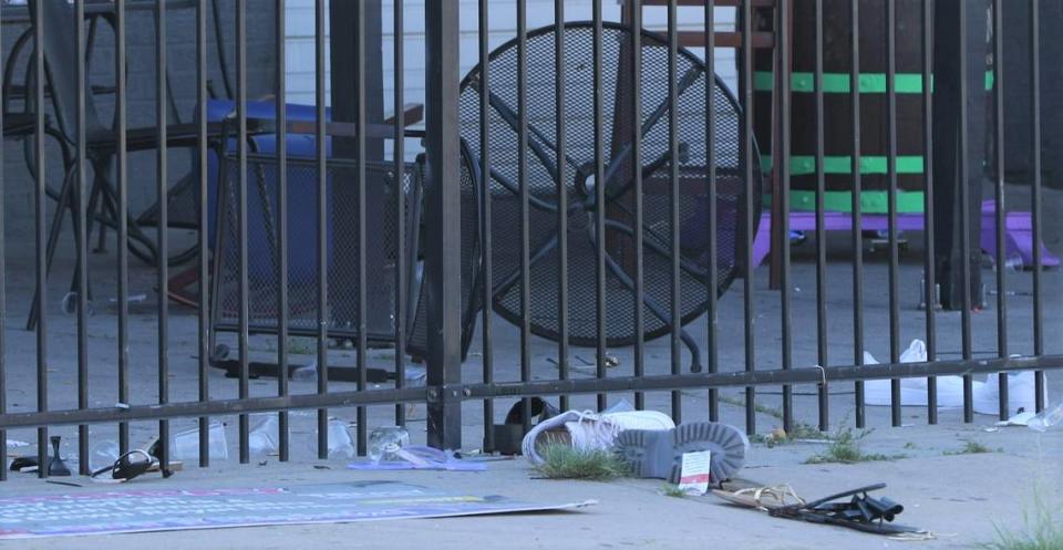 Shoes, sandals, cups and overthrown chairs dotted the patio of City Nightz as crime scene investigators worked the area.