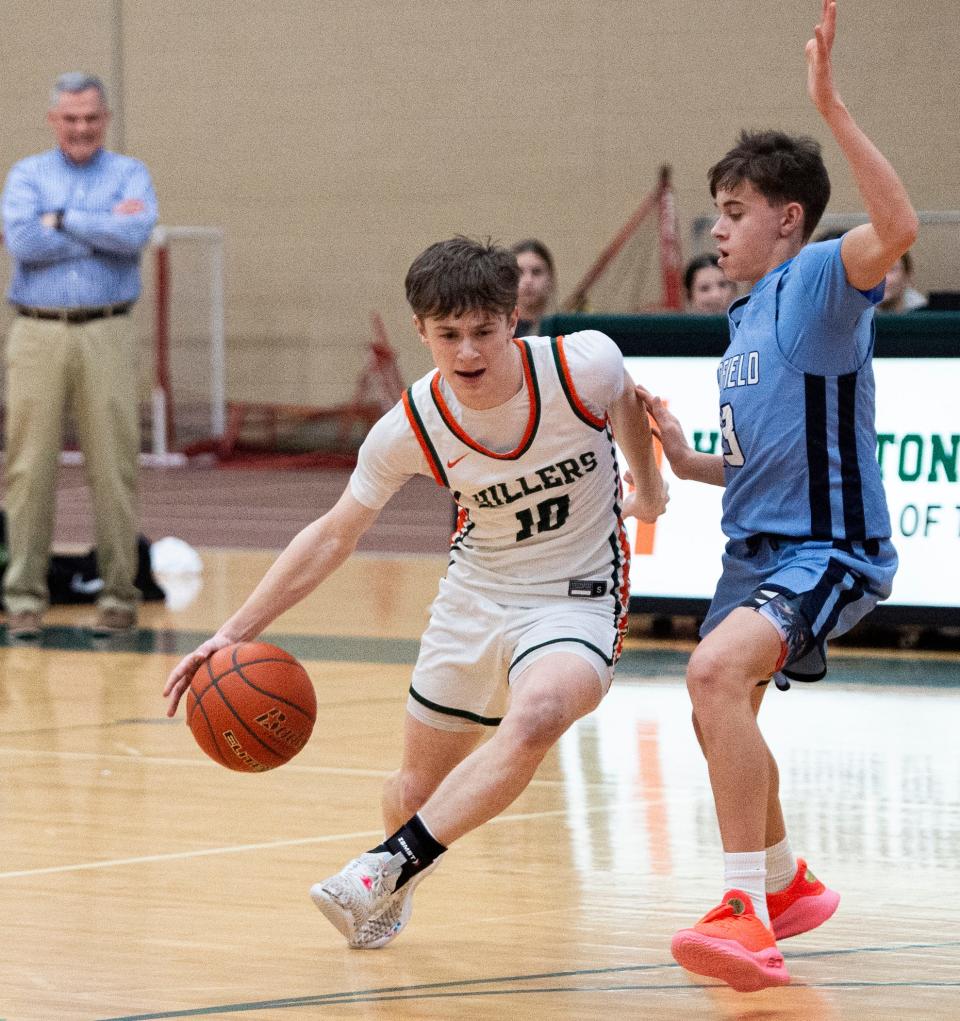 Hopkinton senior captain Jack Ianelli gets around Medfield sophomore Thomas Behrmann during the game in Hopkinton, Feb. 6, 2024. The Hillers beat the Big Blue, 79-57.