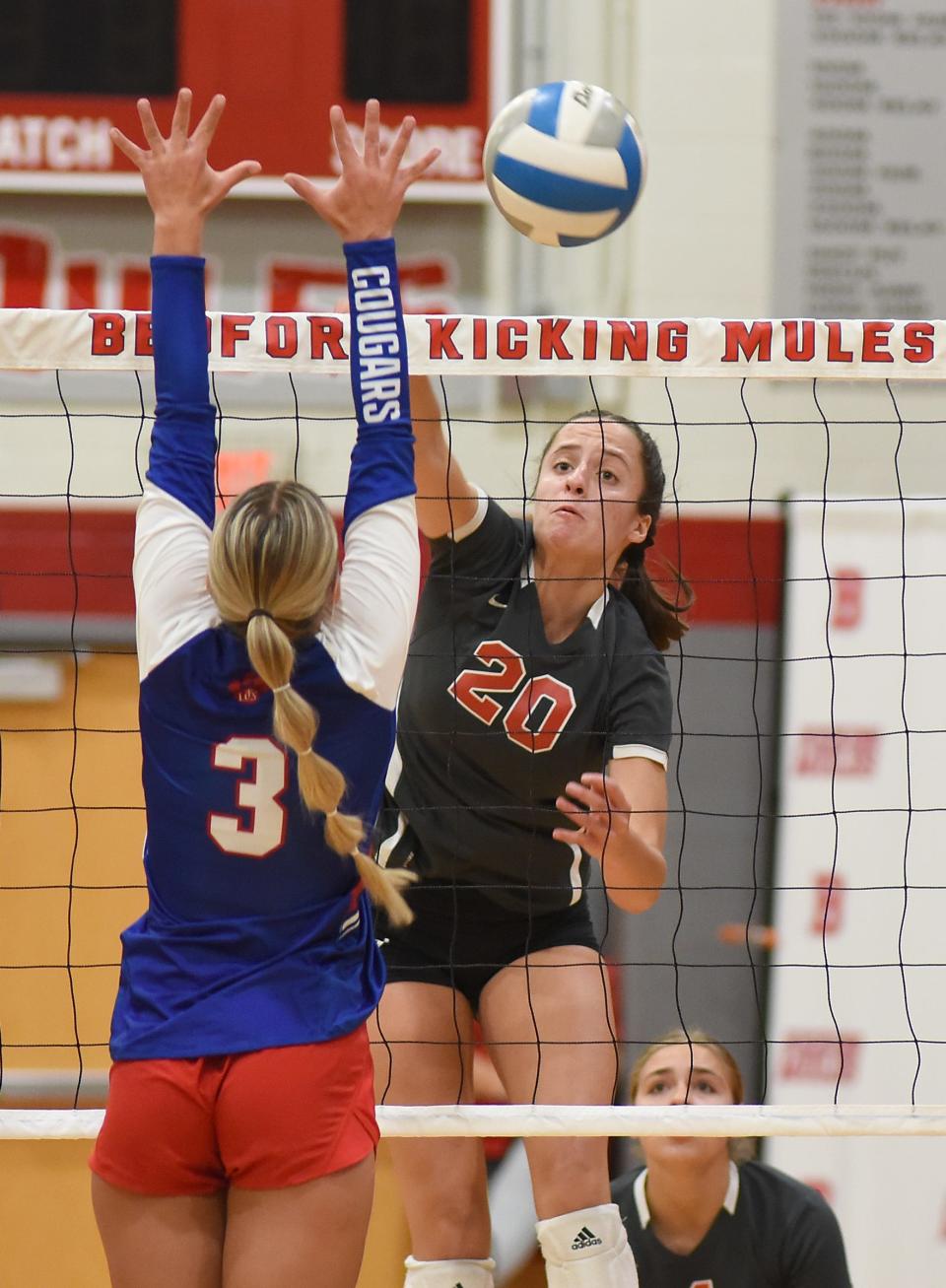 Alivia Brown of Bedford spikes past Gabby Bryja of Lenawee Christian in the Bedford volleyball tournament Friday, September 1, 2023.