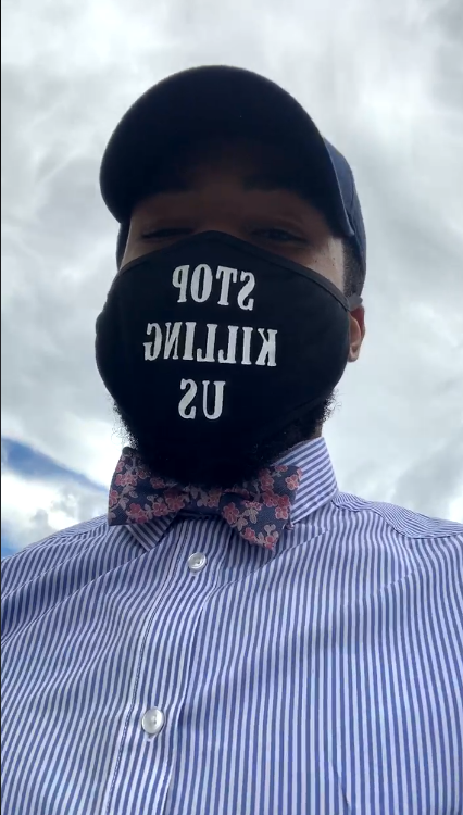 Protest organizer Domari Greene dons a mask that says "Stop Killing Us" at a protest outside the Elmira Police Department on May 29, 2020, after the death of George Floyd in Minneapolis.