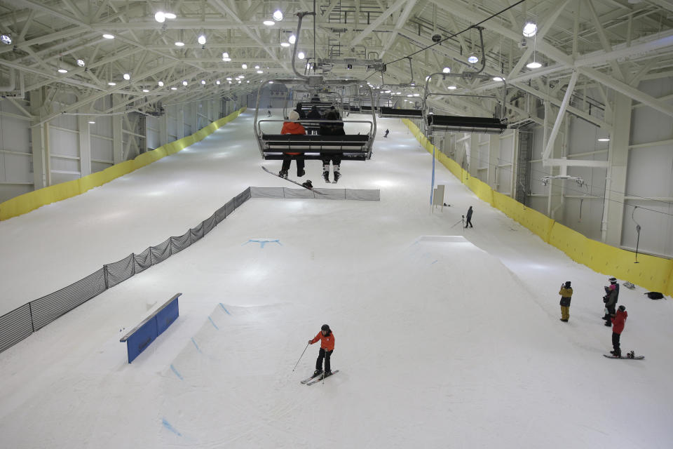 Snowboarders and skiers enjoy the grand opening of Big Snow in East Rutherford, N.J., Thursday, Dec. 5, 2019. The facility, which is part of the American Dream mega-mall, is North America's first indoor ski and snowboard slope with real snow. (AP Photo/Seth Wenig)