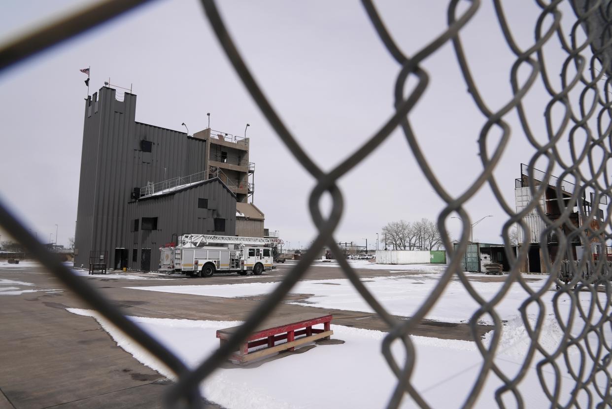 The Denver Fire Academy is visible through a fence from the road Thursday, Feb. 23, 2023, in Commerce City, Colo. Firefighting foam used here up until 2018 is suspected to be linked to the discovery of PFAS, or “forever chemicals” found in city’s groundwater. (AP Photo/Brittany Peterson)