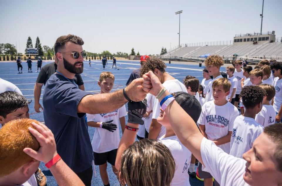 Green Bay Packers tight end and former Bulldog Josiah Deguara encourages children attending the Bulldogs Back Home 2023 football camp on Saturday, June 17, 2023, at Folsom High School. Along with Deguara, current NFL players and former Bulldogs Jack Browning and Jonah Williams — along with former player Jordan Richards — ran the youths through drills alongside head coach Paul Doherty and other Folsom coaches.