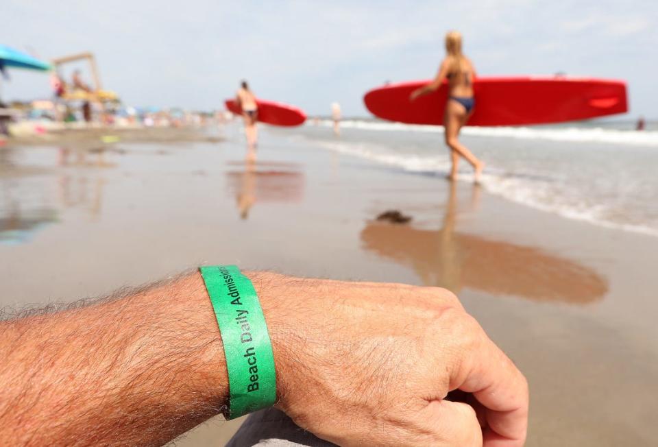 People who don't have season passes to Narragansett Town Beach have to pay a $12 daily admission fee to get a wristband.