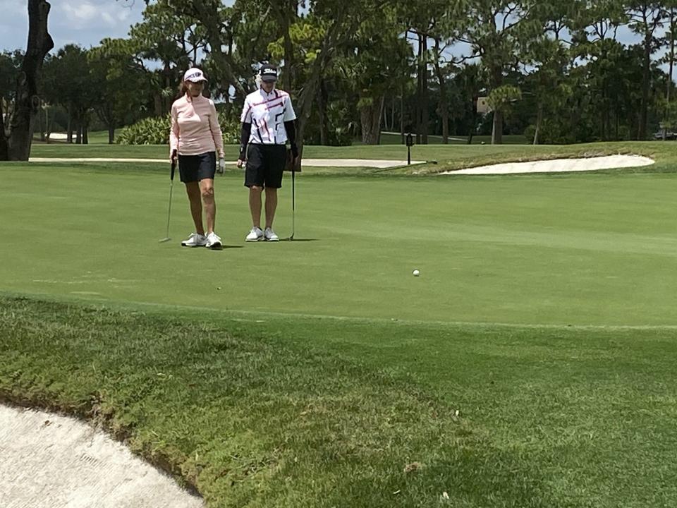 Sue Cohn, left, and Terrill Samuel watch Cohn's birdie putt come up short on the first playoff hole of the Palm Beach County Women’s Amateur Championship Wednesday at PGA National Resort.