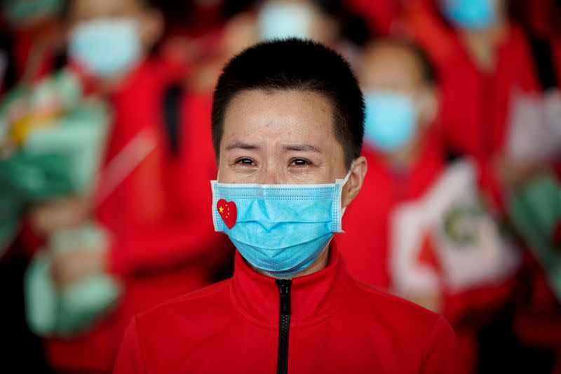 Member of a medical team weeps at the Wuhan Tianhe International Airport