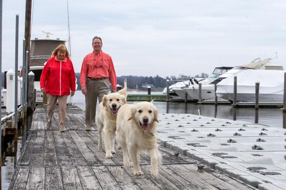 Chan and Christine Irwin, who have sold Irwin Marine, a marina on the Navesink River that has been in their family for 138 years, walk the docks with their dogs, Jack and Connor, at Irwin Marine, which the new owners will name Irwin Marine Center, in Red Bank, NJ Thursday March 23, 2023.  