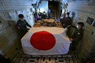 In this photo provided by Japan Joint Staff Office, members of Japan Air Self-Defense Force prepare to arrive at Tonga's Fua'amotu International Airport, near Nuku'alofa, Saturday, Jan. 22, 2022 to deliver aid after an undersea volcano eruption. (Japan Joint Staff Office via AP)