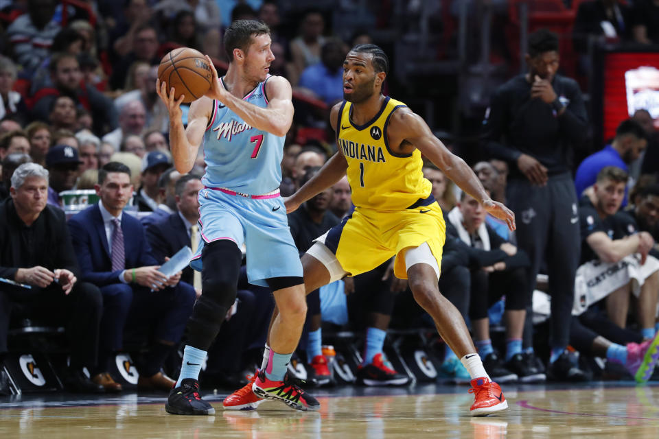 Miami Heat guard Goran Dragic (7) looks for an opening past Indiana Pacers forward T.J. Warren (1) during the first half of an NBA basketball game Friday, Dec. 27, 2019, in Miami. (AP Photo/Wilfredo Lee)