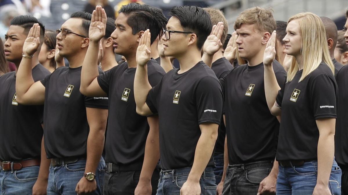 U.S. Military recruits are sworn in during halftime on Salute to Service  military appreciation day at an NFL football game between the Jacksonville  Jaguars and the Las Vegas Raiders, Sunday, Nov. 6